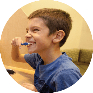 A young boy brushing his teeth